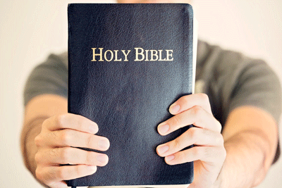 Holding-Up-the-Bible_400x